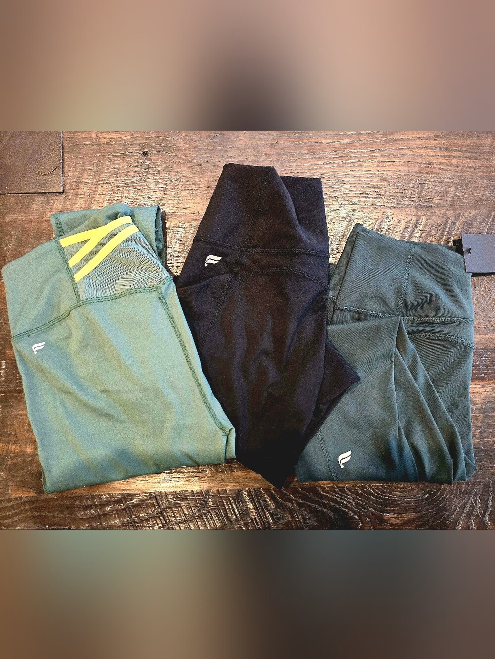 Fabletics Leggings Trio in Olive Green, Black, and Teal with Yellow Accent